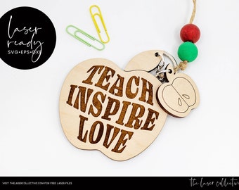 May include: Wooden apple keychain with the text "TEACH INSPIRE LOVE" engraved on it. The keychain has a small apple charm attached to it.