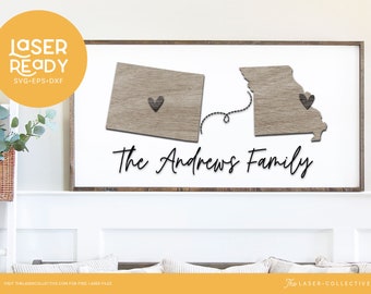 May include: A white wooden sign with a laser cut design of the states of Missouri and Colorado connected by a string with a heart in each state. The text "The Andrews Family" is written below the states.