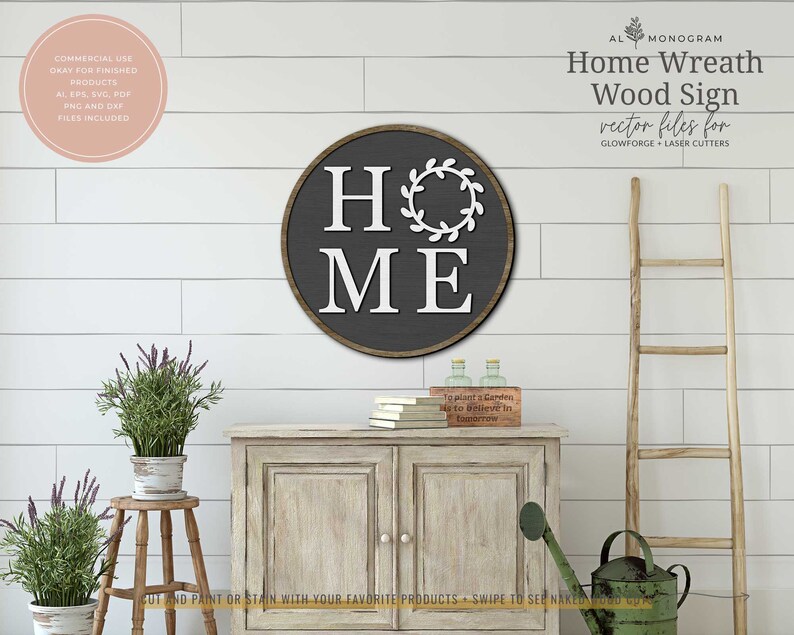 May include: A round wooden sign with a dark gray background and white lettering that reads "HOME" with a wreath around the "O". The sign is on a white shiplap wall with a wooden ladder and a watering can on a table.