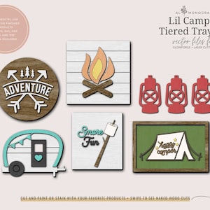 May include: A set of six wooden tiered tray signs with a camping theme. The signs feature a campfire, a lantern, a camper, a tent, and the words "Adventure" and "Smore Fun".