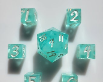 May include: A set of seven turquoise dice with white numbers. The dice are arranged in a circle around a larger turquoise d20 die with white numbers.