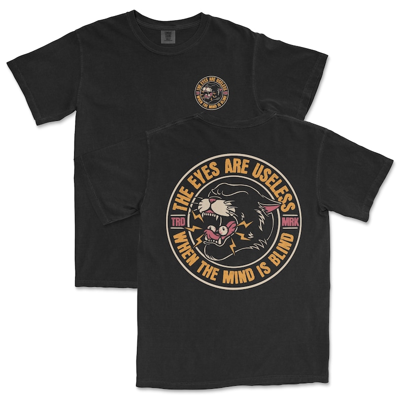 A traditional tattoo shirt featuring a panther with eyes in its mouth and the phrase “The eyes are useless when the mind is blind,” printed on a Comfort Colors tee for fans of tattoo art and alternative clothing.