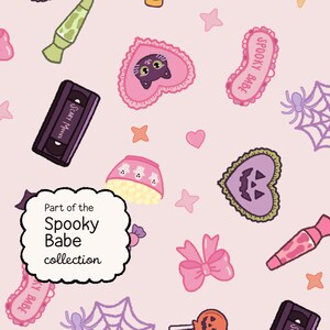 May include: A light pink background featuring a repeating pattern of Halloween-themed icons including black cats in pink hearts, purple jack-o'-lanterns, spider webs, VHS tapes labeled Scary Movies, and bows. A white scalloped label reads Part of the Spooky Babe collection.