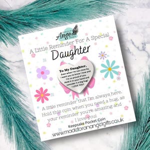 May include: A white card with the text "A Little Reminder For A Special Daughter" and a heart-shaped design. The card includes a message, decorative flowers, and the website www.madeforanangelgifts.co.uk.