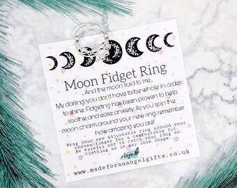 May include: A silver moon charm fidget ring with a card that reads "Moon Fidget Ring - And the moon said to me... My darling, you don't have to be whole in order to shine. Fidgeting has been proven to help soothe and ease anxiety. As you spin the moon charm around your new ring, remember how amazing you are! Wrap your new adjustable ring around your chosen finger for a comfortable fit. Be careful not to catch your ring on clothing as it may lose shape. Ange www.madeforanangelgifts.co.uk"