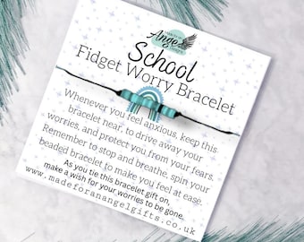 May include: A white card with the text "School Fidget Worry Bracelet" and instructions. A black string bracelet with turquoise beads is attached. The card has a blue star pattern and the words "Made for an Angel Designs".
