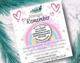 May include: A white card with the text "Always Remember" and a rainbow design. The card includes the phrase "Always remember you're braver than you believe, stronger than you seem, smarter than you think and loved more than you know."