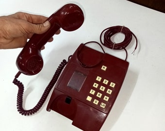 Working burgundy phone. A wired telephone from the times of the USSR. Made in Eastern Europe in the 90s. Push-button landline telephone.