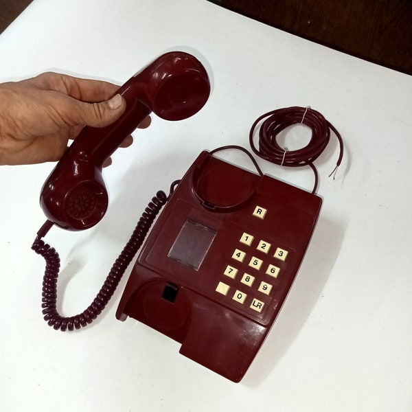 Working burgundy phone. A wired telephone from the times of the USSR. Made in Eastern Europe in the 90s. Push-button landline telephone.