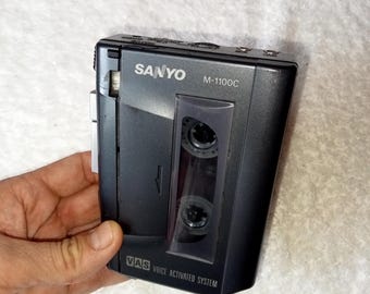 May include: A black Sanyo M-1100C cassette recorder with a voice activated system (VAS).
