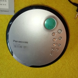 May include: A silver Panasonic SL-CT490 CD player with a green digital display showing 0:47. The player has buttons for volume, memory, mode, and recall.
