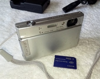 Working Silver Digital Camera Sony Cybershot DSC-T100, 5x Optical Zoom, 8.1 MP, Carl Zeiss Optics, Slider, Slim Compact, Stylish Metal Camera