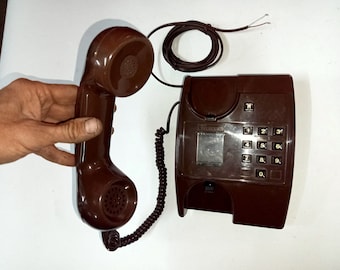 Working brown phone. Corded telephone from the times of the USSR. Made in Eastern Europe in the 90s.Stationary push-button telephone. USSR.