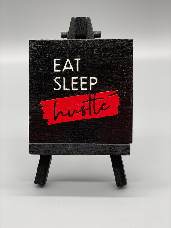 Eat Sleep Hustle wooden sign black background splash of red