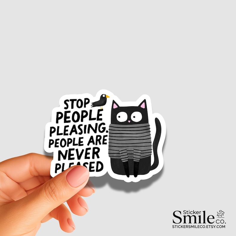 May include: A die-cut vinyl sticker featuring a black cat with wide eyes wearing a gray and black striped sweater. Next to the cat is a small black bird and the text: STOP PEOPLE PLEASING. PEOPLE ARE NEVER PLEASED. The sticker has a white border.
