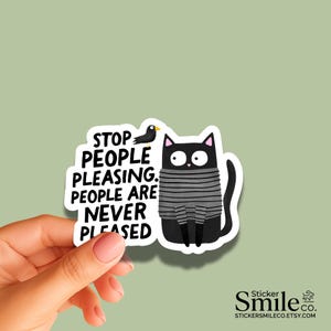 May include: A die-cut sticker featuring a black cat wearing a gray striped sweater, a small black bird, and the black text: STOP PEOPLE PLEASING. PEOPLE ARE NEVER PLEASED. The sticker has a white border and a cartoon illustration style.