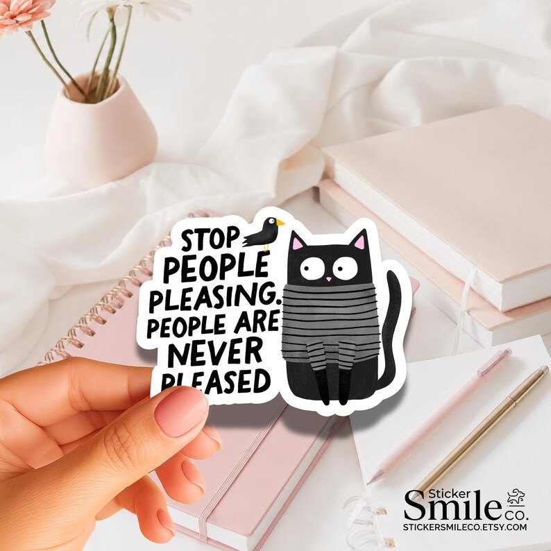 May include: A die-cut sticker featuring a black cat wearing a gray and black striped sweater. The cat has wide eyes and is next to a small black bird. The text reads: STOP PEOPLE PLEASING. PEOPLE ARE NEVER PLEASED. The sticker has a white border.
