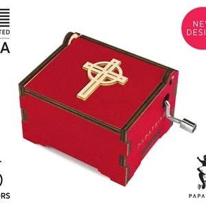 May include: Red wooden music box with a Celtic cross design on the lid. The box has a hand crank on the side and the words "Papa Trike" are printed on the side.