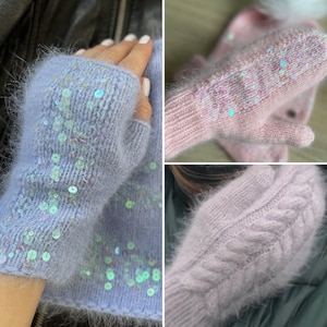 May include: Three pairs of fuzzy knit fingerless gloves. One pair is light blue with iridescent sequins, one pair is pink with iridescent sequins, and one pair is a light pink cable knit.