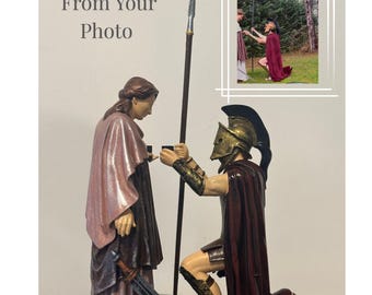 May include: A figurine depicting a kneeling warrior in gold armor and a burgundy cape, offering a small box to a woman in a pink robe. A spear and sword are also present. The text "From Your Photo" is at the top.