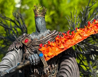 May include: A detailed figurine of a knightly figure, wearing a crown and holding a flaming sword. The figure is clad in dark armor with ornate detailing, including red and blue gemstones. The sword blade is a vibrant orange and red, depicting flames.