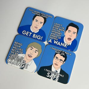 May include: Four blue square coasters with cartoon illustrations of men and humorous text. The coasters feature phrases like "Get Big!" and "I thought it was safe."