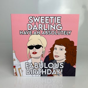 May include: Pink greeting card with a cartoon illustration of two women. The text on the card reads "Sweetie Darling Have an Absolutely Fabulous Birthday!"