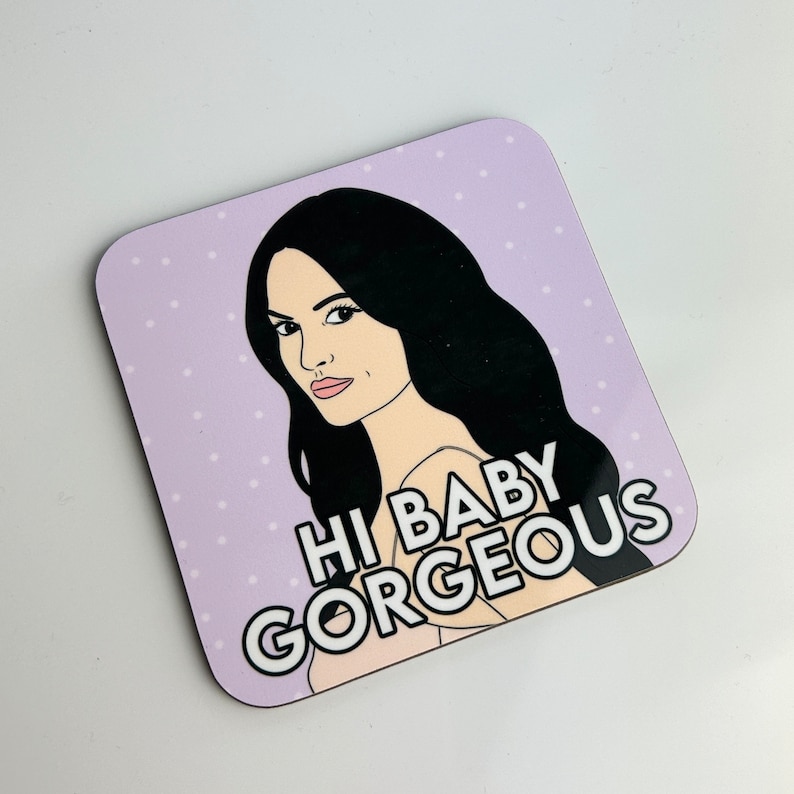 Peut inclure: Un dessous de verre violet et blanc avec une illustration de dessin anim&eacute; d'une femme aux longs cheveux noirs et le texte "Hi Baby Gorgeous".