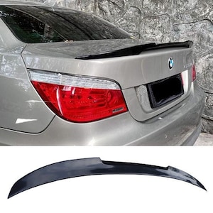 May include: A black rear spoiler for a car. The spoiler is made of a durable material and is designed to improve the car's aerodynamics.