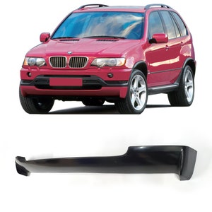 May include: A black plastic car bumper replacement for a red SUV. The bumper is designed to fit the front of the vehicle and has a smooth, sleek finish.
