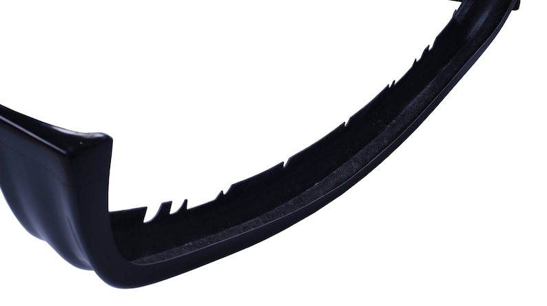 May include: Black plastic car bumper with a textured surface and a jagged edge.