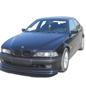 Puede incluir: Un sed&aacute;n BMW negro con un aler&oacute;n delantero. El coche tiene una parrilla y faros negros.