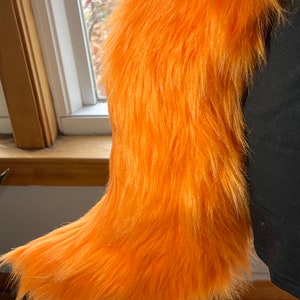 16.  Orange faux fur wolf tail