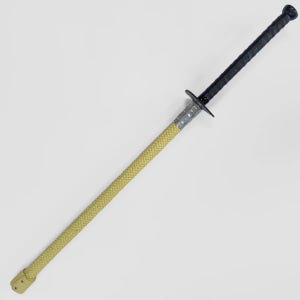 May include: A long, slender staff featuring a textured, light yellow braided cord covering the majority of its length. It includes a black, textured handle at one end, separated from the yellow section by a small, dark, cross-shaped guard.
