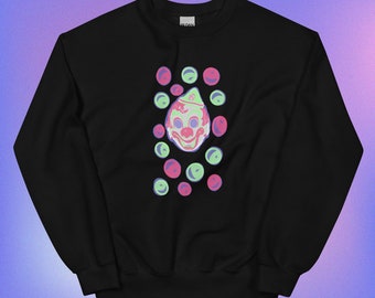 May include: Black sweatshirt with a green and pink clown face graphic and a pattern of green and pink circles.