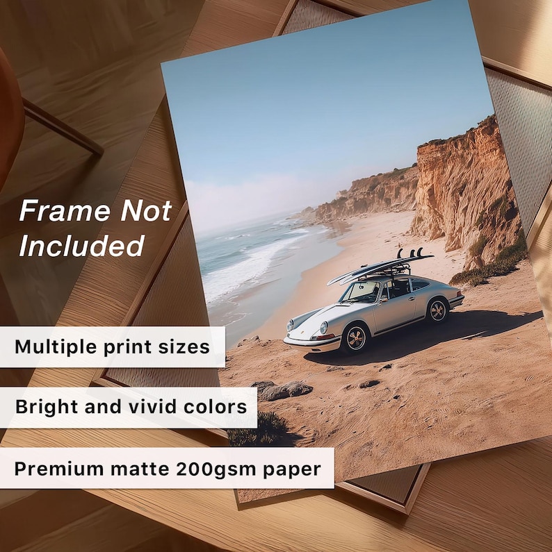 May include: A print featuring a vintage silver car with surfboards parked on a sandy cliff overlooking the ocean. The print has bright and vivid colors and is printed on premium matte 200gsm paper. The text on the print says "Frame Not Included" and "Multiple print sizes".
