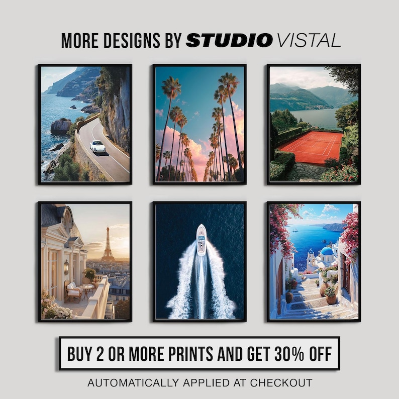 May include: Six framed art prints featuring scenic landscapes. The prints showcase a coastal road, palm trees, a tennis court, a Parisian balcony, a boat on the water, and a Mediterranean village. Text reads "MORE DESIGNS BY STUDIO VISTAL".