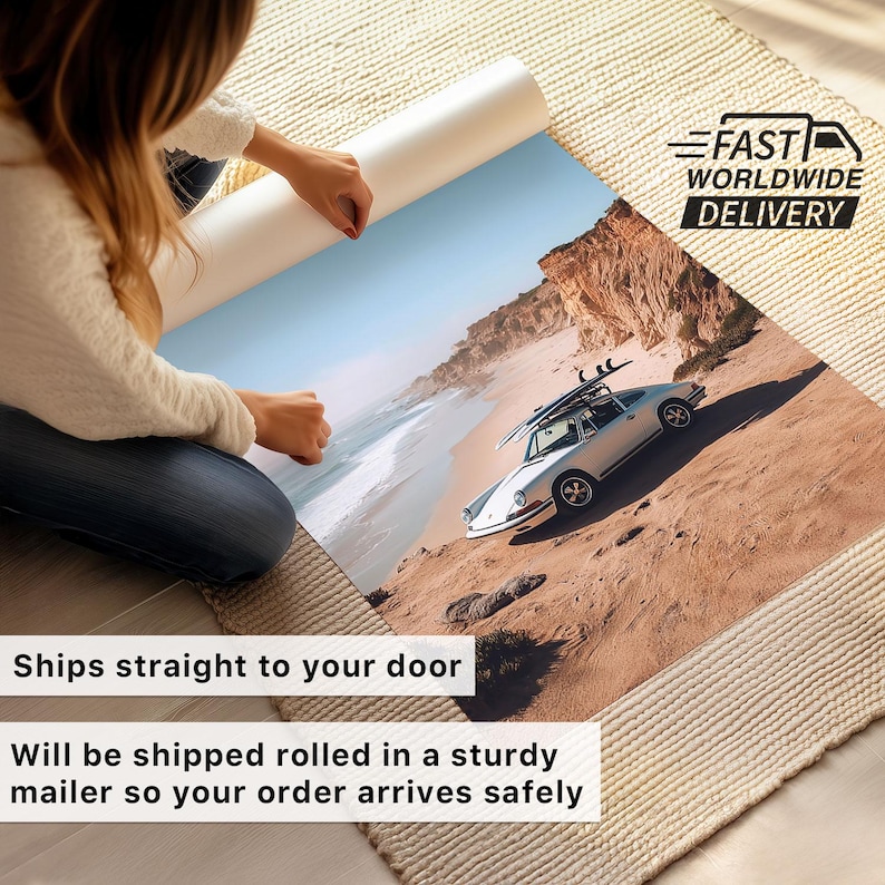 May include: A rolled print of a coastal scene featuring a white vintage car with surfboards parked on a sandy hillside. The print is being unrolled, revealing a beach and ocean under a blue sky. The text "Ships straight to your door" is visible.