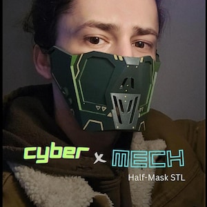 Puede incluir: Una persona lleva una media máscara verde y negra con un diseño geométrico. La máscara tiene el texto "cyber x MECH" y "Half-Mask STL" impreso en ella.