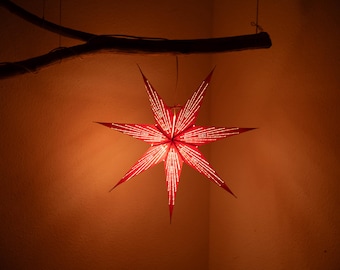 Estrella de papel roja, estrella de Navidad, temporada de Adviento, papel brillante