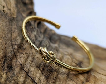 Golden brass bangle with knot