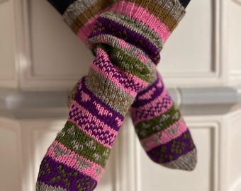 May include: A pair of warm, cozy socks with a colorful striped pattern in shades of pink, purple, green, and gray. The socks are made of wool and have a comfortable fit.