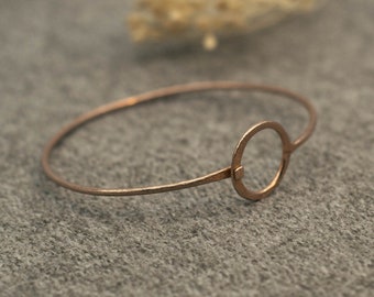 Minimalist rose-colored bangle with circle ornament