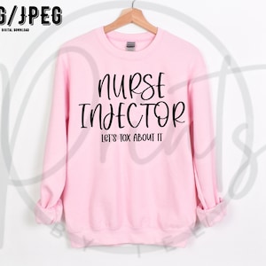 May include: Pink sweatshirt with black text that reads "Nurse Injector Let's Tox About It"