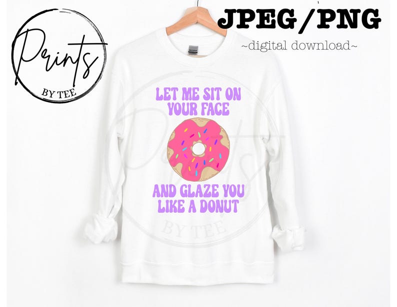 May include: White sweatshirt with a pink and white donut graphic and the text "Let me sit on your face and glaze you like a donut".