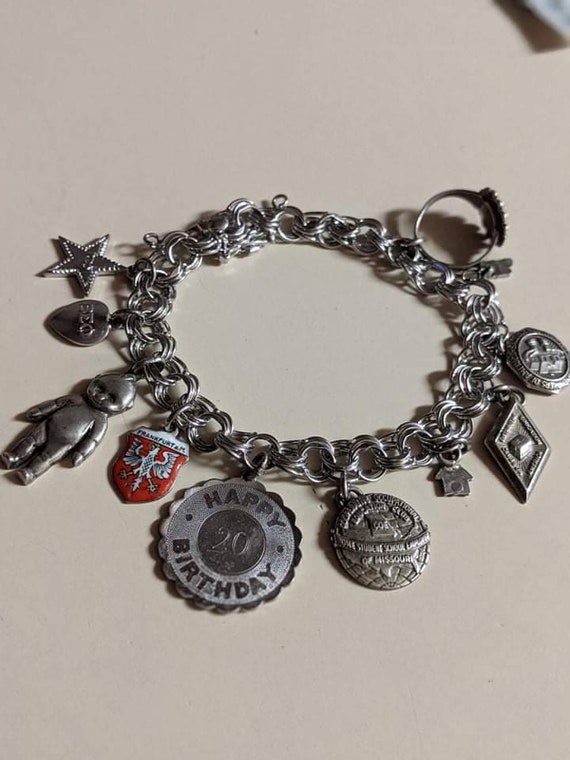 Sterling silver charm bracelet with eleven charms - image 1