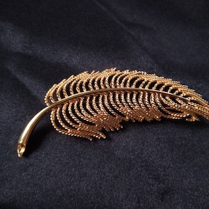 Monet gold feather brooch