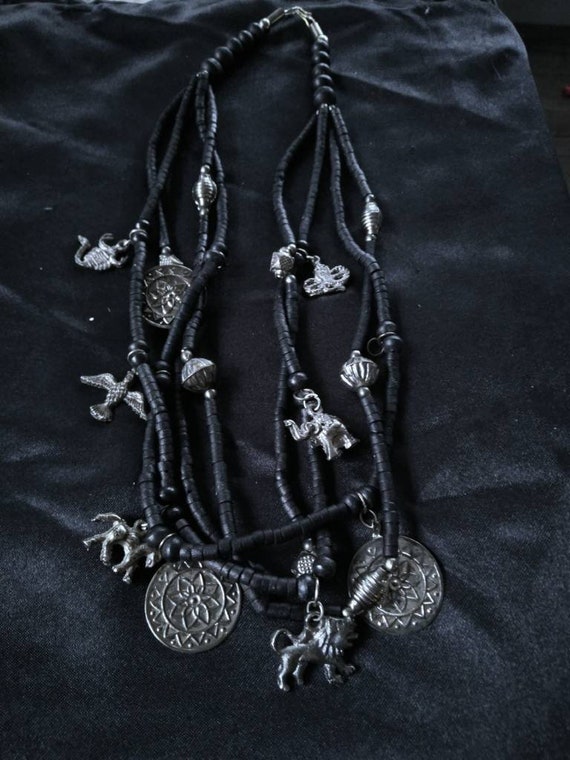 Four strand black beaded necklace with animal char