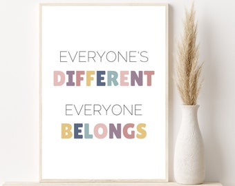 May include: A framed print with the text "Everyone's Different Everyone Belongs" in colorful letters. The letters are in different colors, including pink, yellow, blue, and purple.