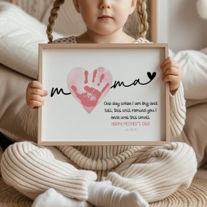 Peut inclure: Une impression encadr&eacute;e avec une empreinte de main rose en forme de c&oelig;ur. L'impression dit "m  ma" et "Un jour, quand je serai grand et grand, cela te rappellera que j'&eacute;tais autrefois si petit. Joyeuse f&ecirc;te des m&egrave;res !"